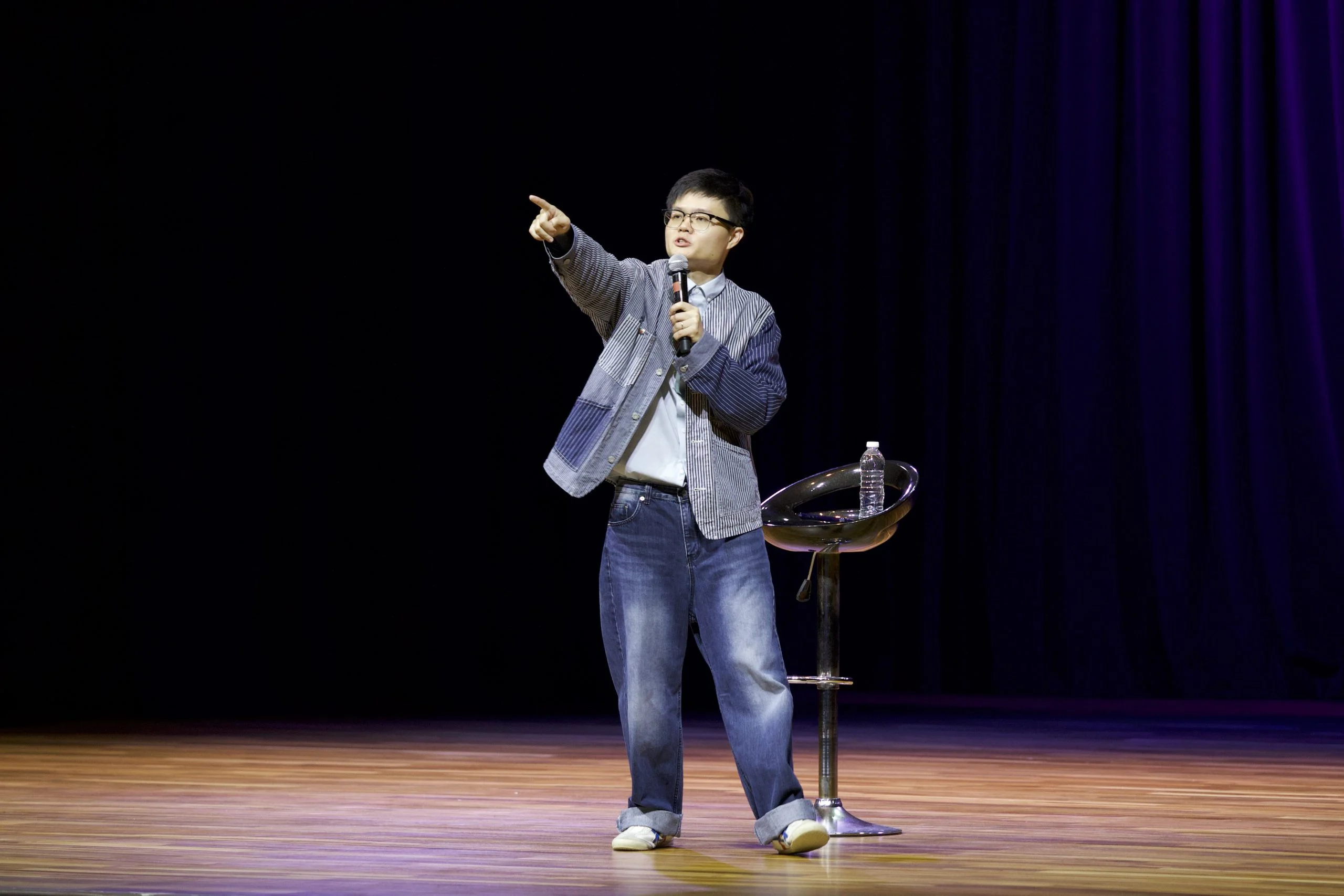 Lucas Lee performing on stage with a microphone